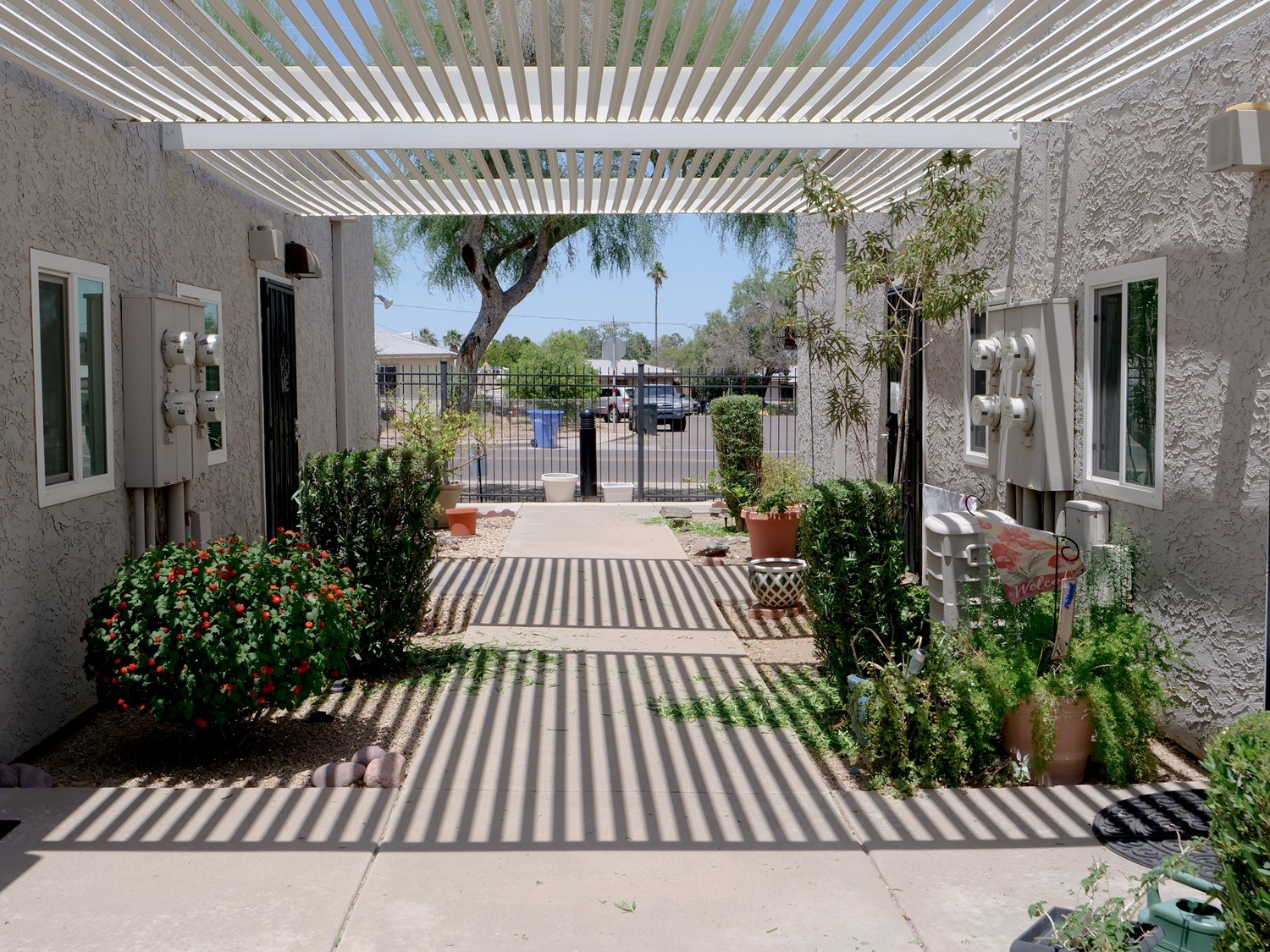 A striped walkway leads to a building entrance.